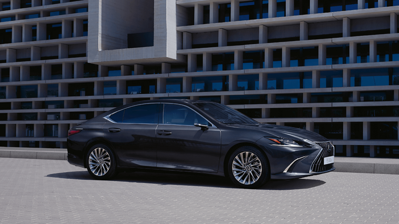 A black Lexus ES 300h driving on a road