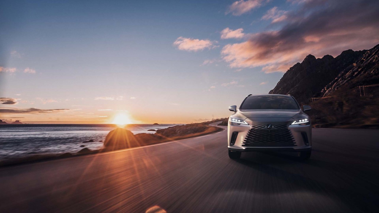 A Lexus RX driving on a coastal road 